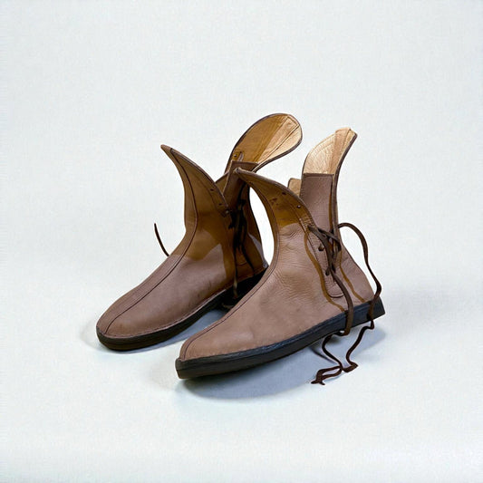 Handmade Medieval Leather Boots displayed on a neutral background, showcasing unique design and craftsmanship.