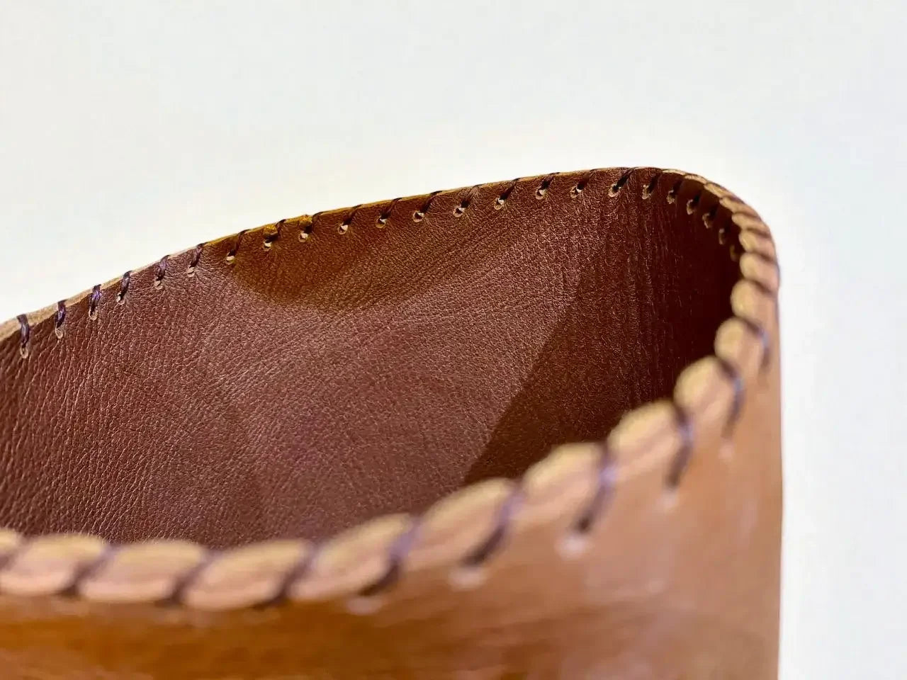 Close-up of handmade medieval leather boot with full-grain texture and detailed stitching